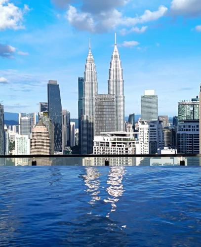 a view of a city skyline from the water at The Luxe & Colony Infinitum KLCC by CoupleStay in Kuala Lumpur