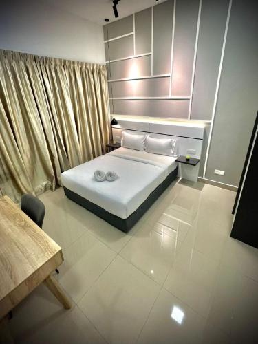a bedroom with a bed with white sheets and pillows at The Luxe & Colony Infinitum KLCC by CoupleStay in Kuala Lumpur