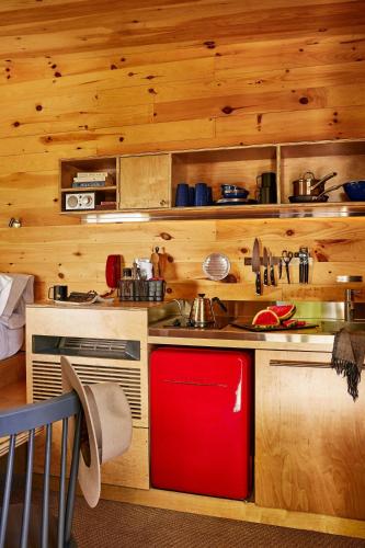 a kitchen with a red refrigerator next to a sink at Postcard Cabins Wild Rose, Outdoor Collection by Marriott Bonvoy in Wild Rose