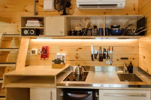 a kitchen with a sink and a counter top at Postcard Cabins Kettle River, Outdoor Collection by Marriott Bonvoy in Willow River