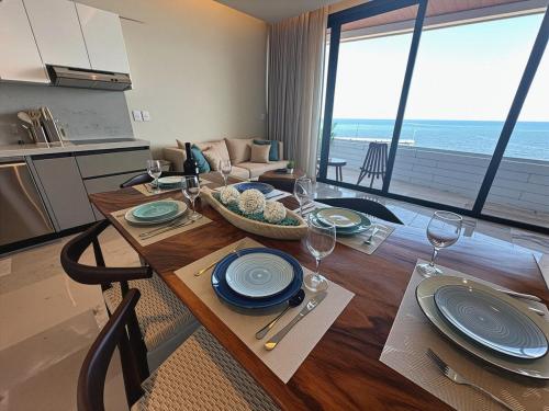 a dining room table with a view of the ocean at Beachfront 2BR 2BA Condo w Balcony, Ocean Views in Puerto Morelos