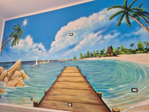 Un mural de una playa con un muelle de madera. en Air Bed - Milano Malpensa Airport, en Cardano al Campo