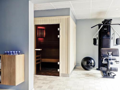 a door leading into a room with a gym at Mercure Lyon Charbonnières in Charbonnières-les-Bains