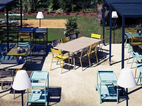 a group of tables and chairs under a tent at Mercure Lyon Charbonnières in Charbonnières-les-Bains