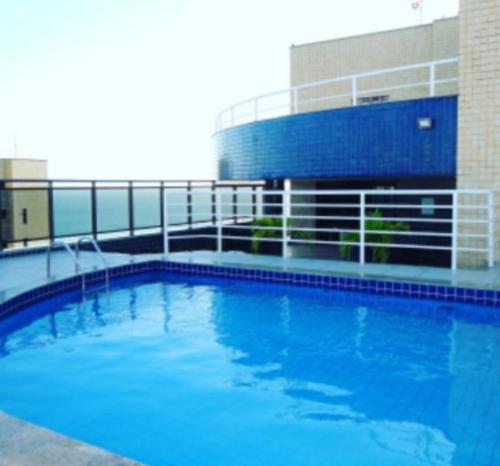 a large blue swimming pool in front of a building at Ocean Atlantic Praia de Iracema in Fortaleza