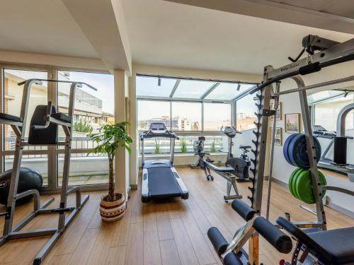 a gym with several tread machines in a room at Mercure Toulouse Centre Saint-Georges in Toulouse