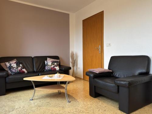 a living room with a couch and a coffee table at Ferienhaus mit Weitblick bei Medebach in Medebach