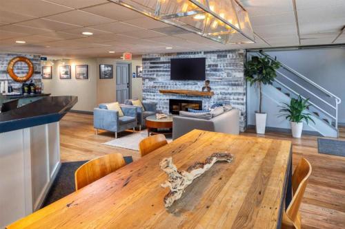 a conference room with a wooden table and a fireplace at Harbor Town Inn, BW Signature Collection in Manitowoc