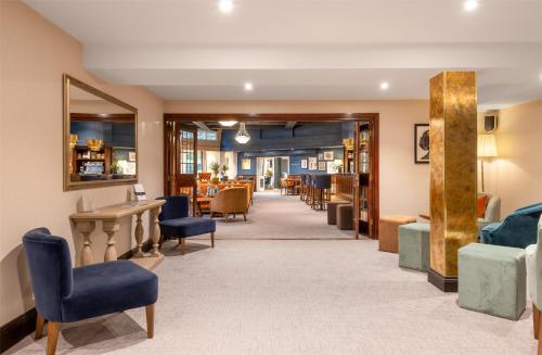 a waiting area in a hospital with chairs and tables at Thatchers, BW Signature Collection in East Horsley