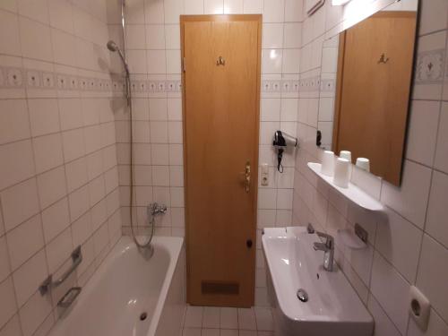 a bathroom with a shower and a tub and a sink at Lush apartment in Bayrischzell with 2 saunas in Bayrischzell