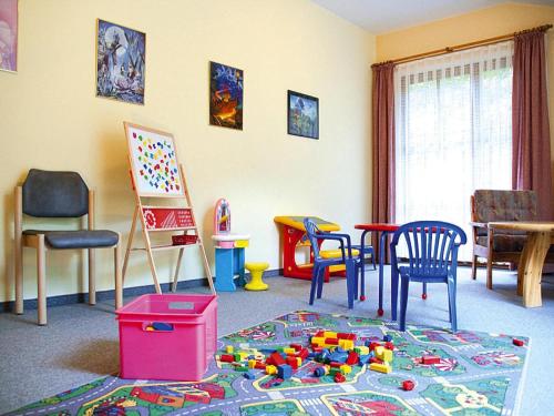 a room with chairs and toys on the floor at Lush apartment in Bayrischzell with 2 saunas in Bayrischzell
