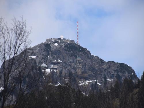 a mountain with a red pole on top of it at Lush apartment in Bayrischzell with 2 saunas in Bayrischzell
