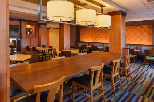 a large dining room with a large wooden table and chairs at Fairfield Inn & Suites Santa Maria in Santa Maria