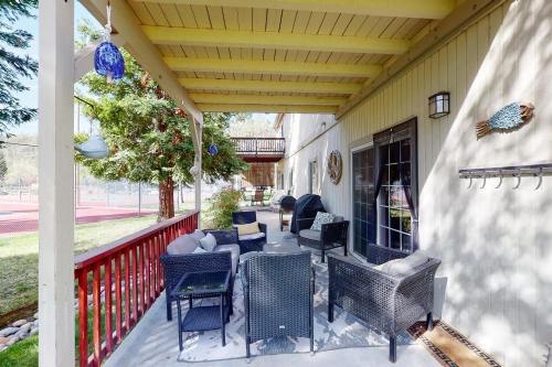 a patio with chairs and tables on a porch at Northshore Lakeview Getaway in Bass Lake