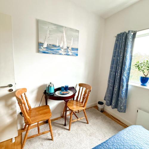 a small room with a table and two chairs at The Blue Haven - Calm and Cozy Stay in Cork
