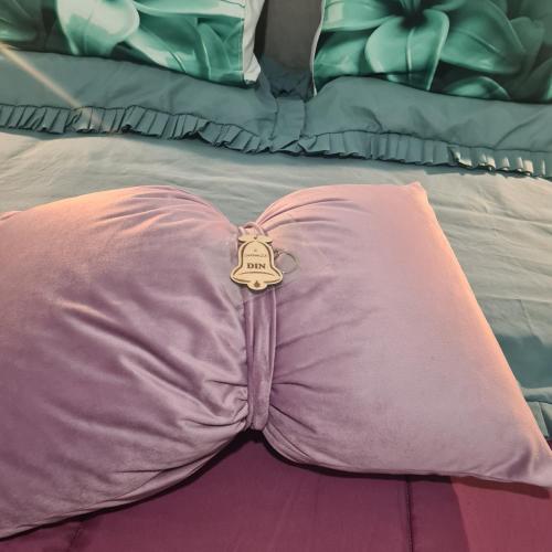a pink pillow with a key on top of a bed at Il Campanile in Santa Maria del Molise