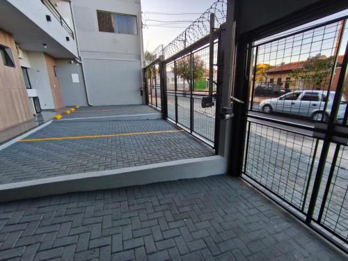 an open door of a building with a parking lot at Xavi Studio in Bauru