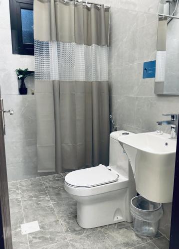 a bathroom with a toilet and a sink at Modern Apartment 2 in Jeddah