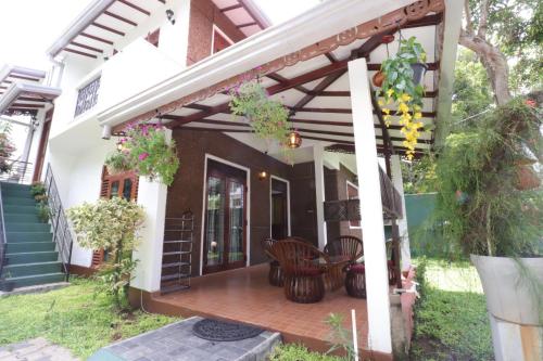 a patio of a house with a wooden deck at Mani Villa in Wattala