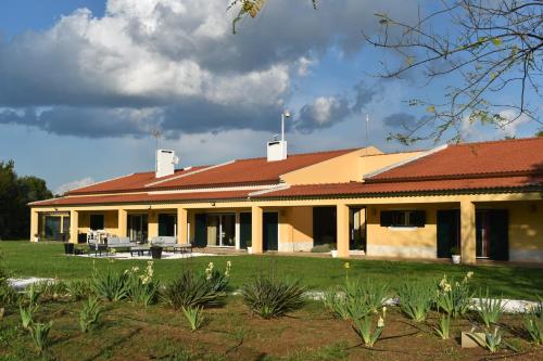 a large yellow building with a red roof at Quinta da Corticeira in Elvas