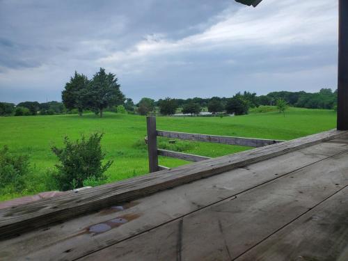 a view of a field and a wooden fence at Lodge One with Scenic View in McKinney