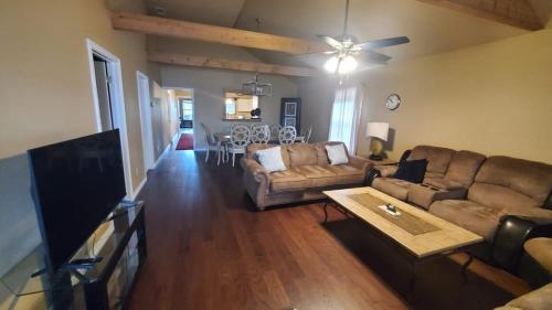 a living room with a couch and a table at Lodge One with Scenic View in McKinney