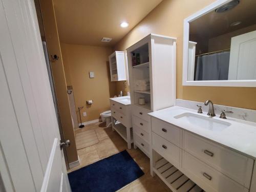 a bathroom with two sinks and a large mirror at Lodge One with Scenic View in McKinney