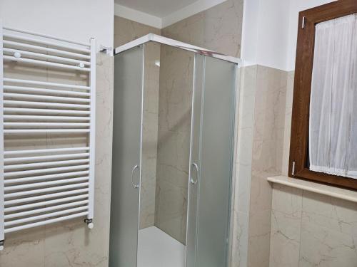 a shower with a glass door in a bathroom at L'antico Orologio in Isola Capo Rizzuto