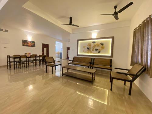 a living room with a couch and chairs and a table at La Tamara Luxury - TIE Hotels & Resorts in Pondicherry