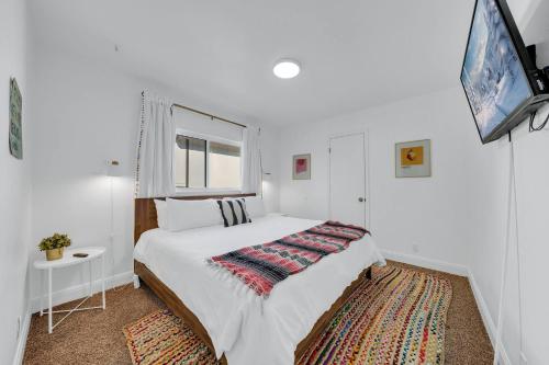 a white bedroom with a bed and a window at Quiet Family Friendly Getaway - Pool, 2 King Beds in San Antonio