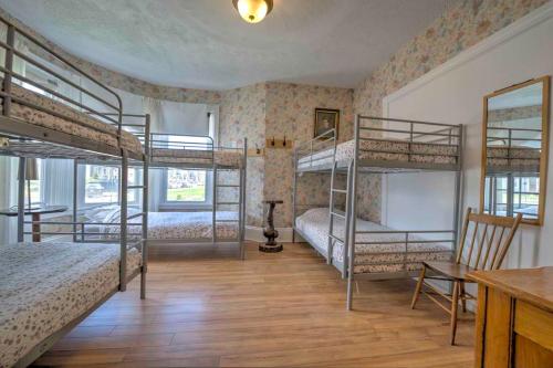 a bedroom with four bunk beds and a desk at HI Charlottetown Backpacker's Inn in Charlottetown