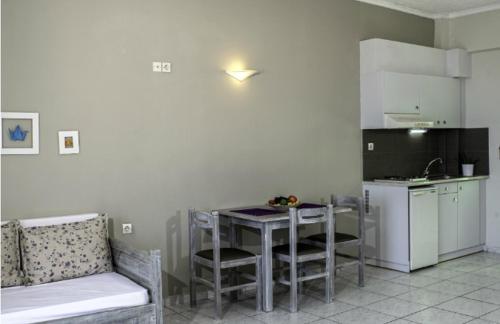 a kitchen with a table and a kitchen with a couch at Artemis Studios in Plakias