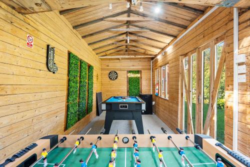 a pool room with a ping pong table in it at Stylish 4-Bed Cambridge Stay - Garden & Games Room in Cherry Hinton