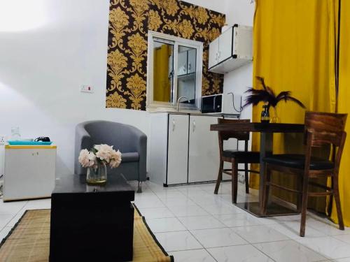 a living room with a table and a kitchen at The Fair Havens Suite in Freetown