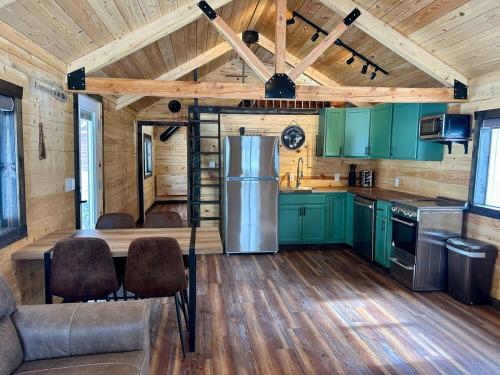 a kitchen with green cabinets and a refrigerator at Index Peak Cabin 