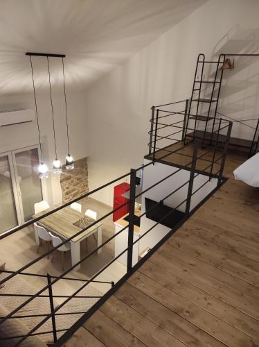 a living room with a glass table and a bed at Puerta de los Castañares A in Constantina