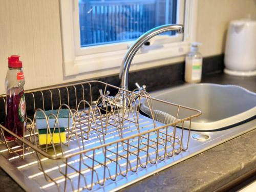 a dish drying rack sitting on a kitchen sink at Birchington Vale Trieste - Sleeps 8, pet friendly & Family friendly in Birchington