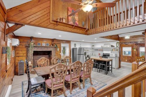 a dining room and kitchen with a table and a fireplace at Cabin in Long Pond Gameroom Pool Table in Long Pond