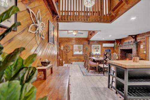a living room with wooden walls and a dining room at Cabin in Long Pond Gameroom Pool Table in Long Pond