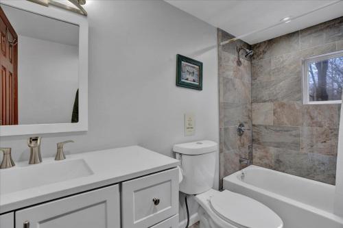 a bathroom with a toilet and a sink and a tub at Cabin in Long Pond Gameroom Pool Table in Long Pond