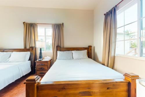 a bedroom with two beds and a window at Grama Tasha at Isebei Guest House -Gold Standard Certified in Hopkins