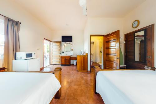 a hotel room with two beds and a kitchen at Grama Tasha at Isebei Guest House -Gold Standard Certified in Hopkins