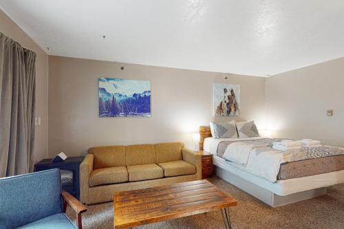 a hotel room with a bed and a couch at Yosemite West Condo B104 in Yosemite West