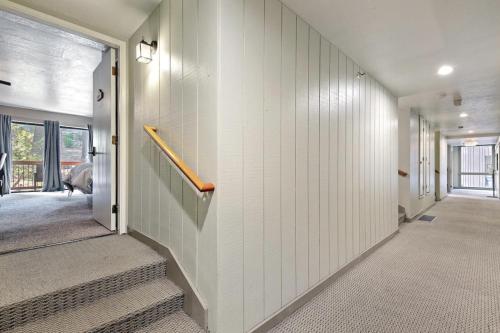 a hallway with white walls and stairs in a house at Yosemite West Condo B104 in Yosemite West