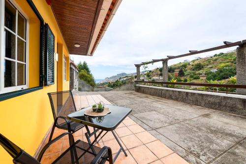 un patio con tavolo e sedie su un balcone di Sol Poente by GALMI a Santo António