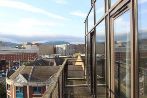 a view of a city from the window of a building at Custom House Square Penthouse in Belfast