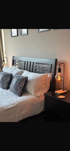 a bedroom with a bed with two pillows on it at Custom House Square Penthouse in Belfast