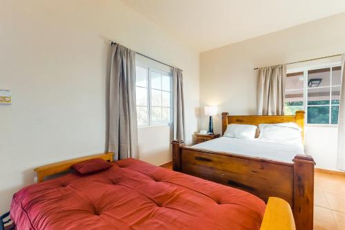 a bedroom with a bed and a large window at Grampa Puli at Isebei Guest House -Gold Standard Certified in Hopkins