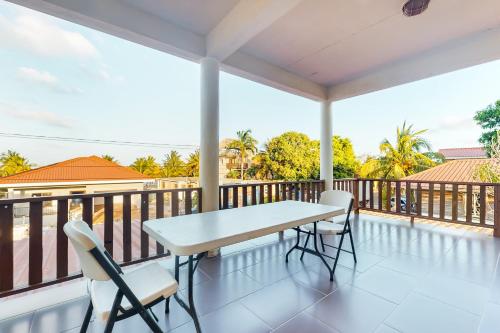 a balcony with a white table and chairs at Grampa Puli at Isebei Guest House -Gold Standard Certified in Hopkins