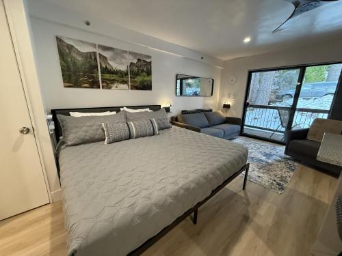 a bedroom with a large bed and a living room at Yosemite West Retreat B105 in Yosemite West